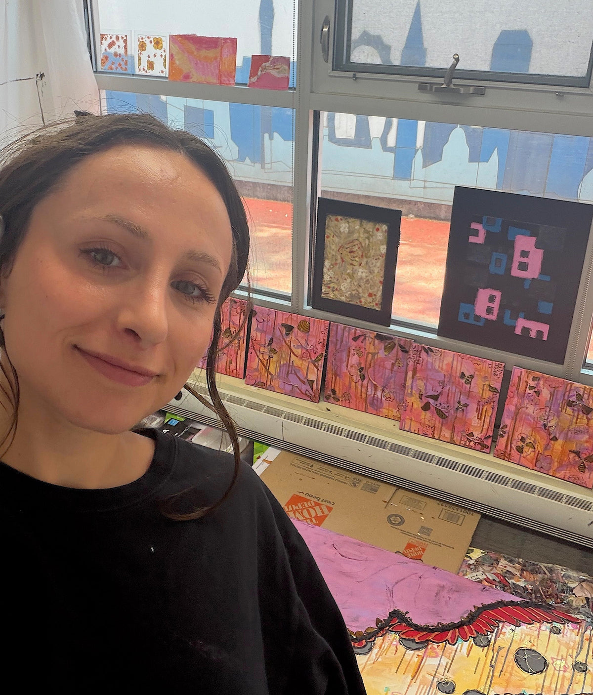 Chaos On Canvas founder Steph smiling in front of her artwork